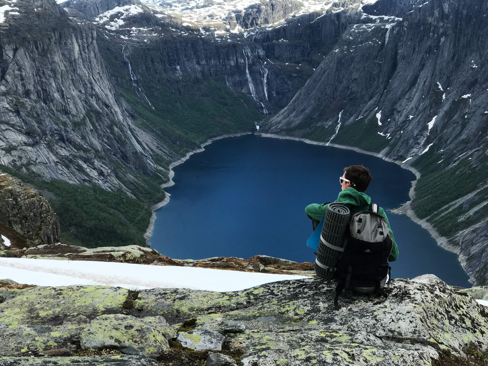 man-with-rucksack-admires-gorgeous-mountain-landscape