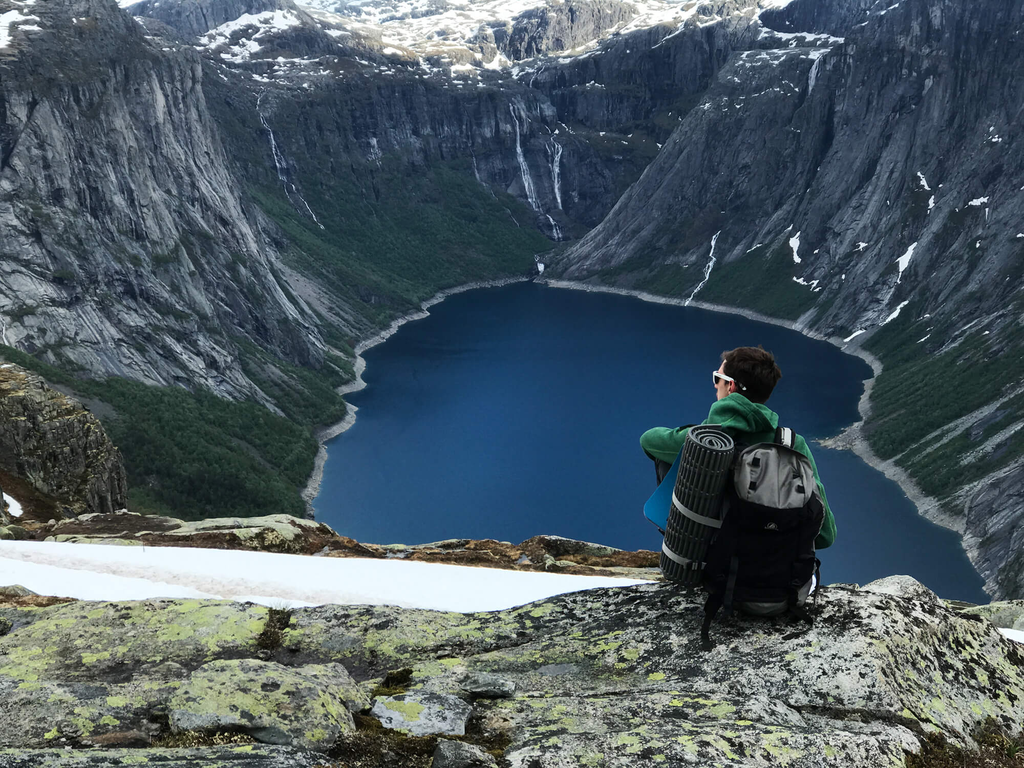 man-with-rucksack-admires-gorgeous-mountain-landscape